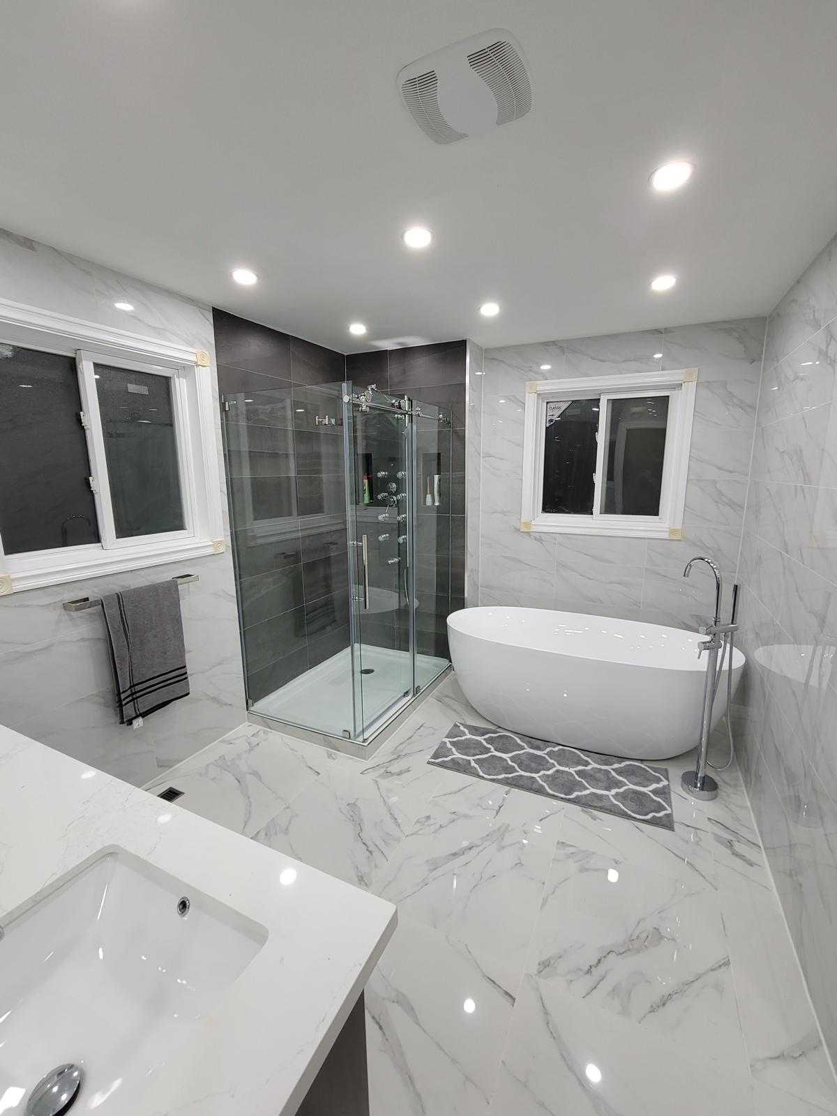 Modern marble bathroom with walk-in glass shower
