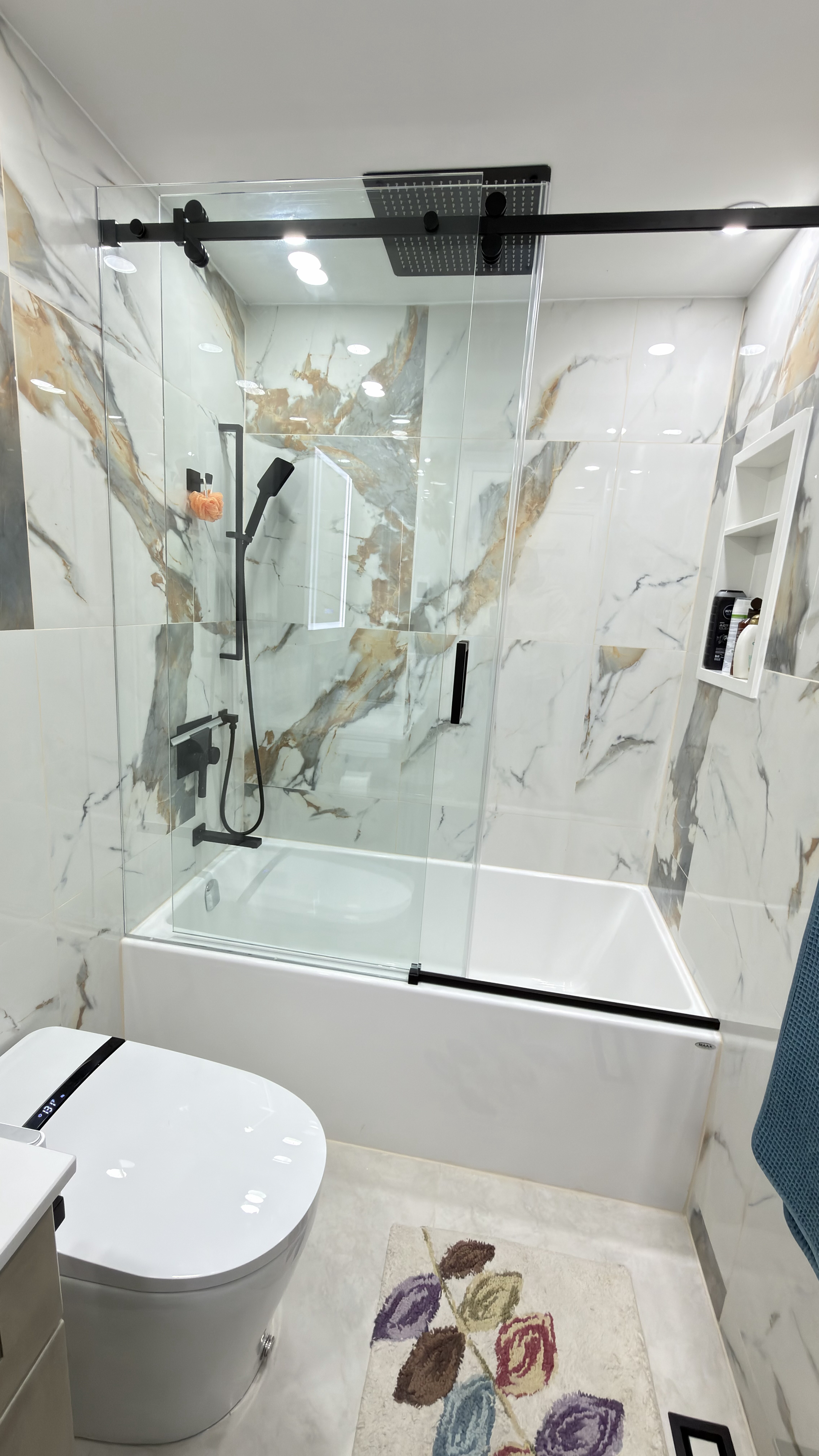 Calacatta marble tub and shower with black hardware