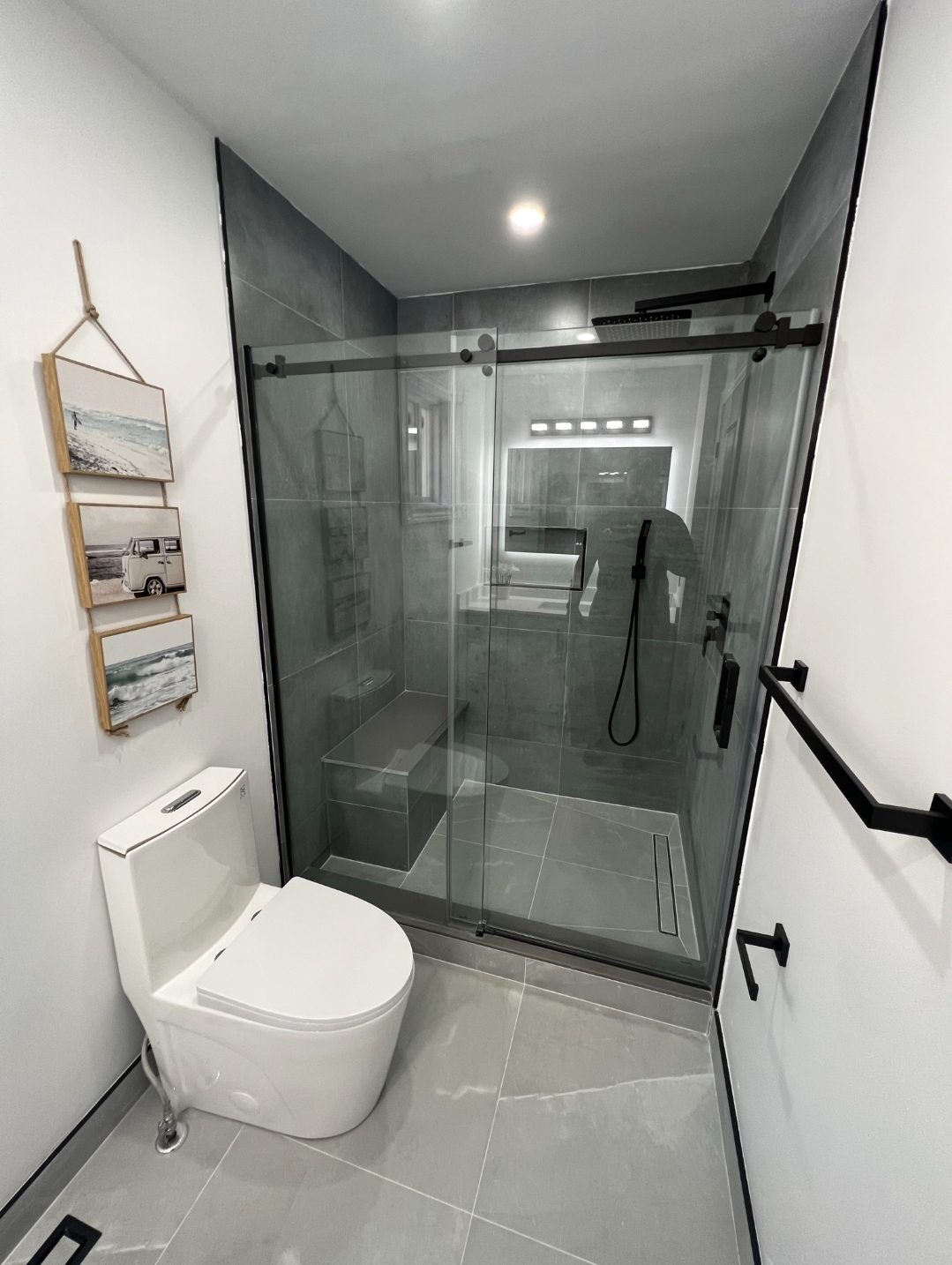 Matte black walk-in shower with grey tile